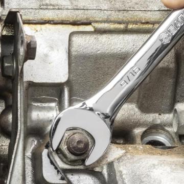close up of hand using wrench on machinery